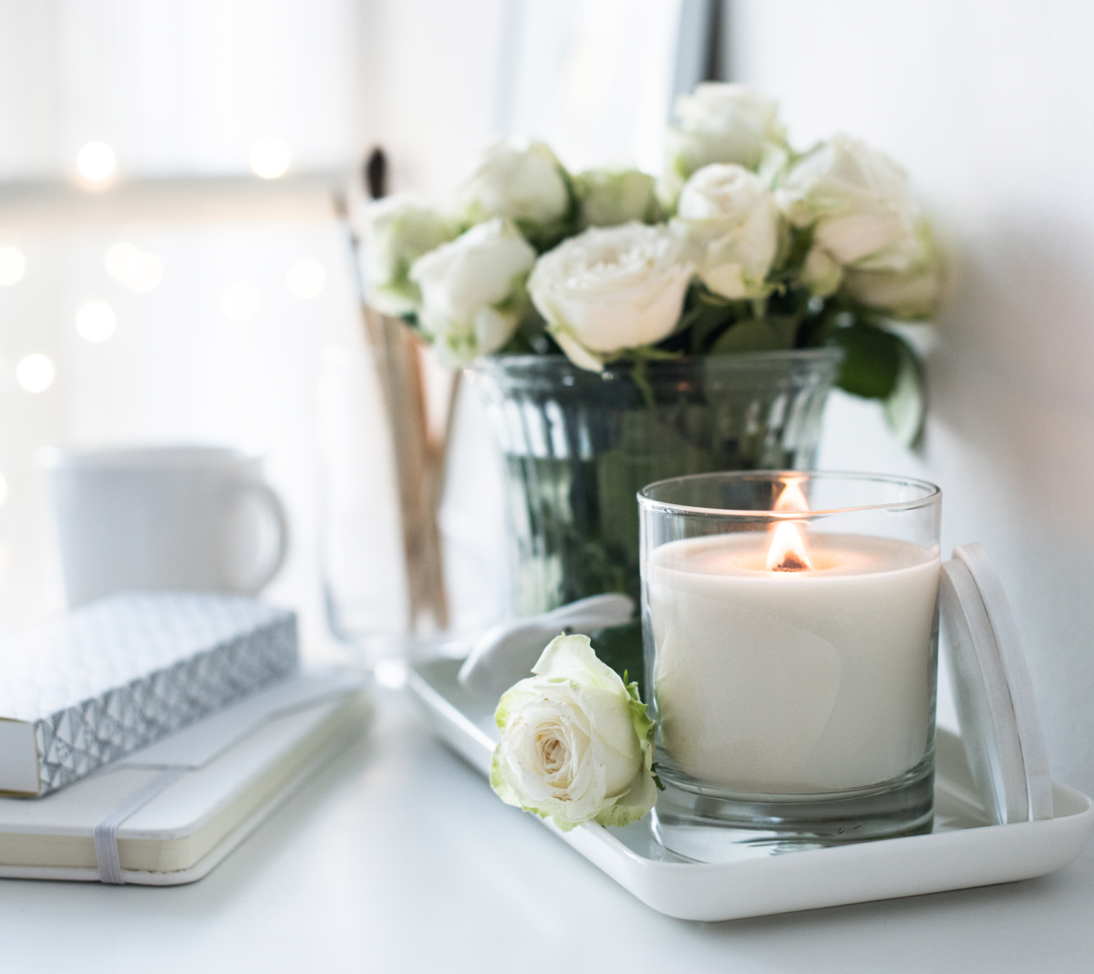 Cozy white roses and candle setting